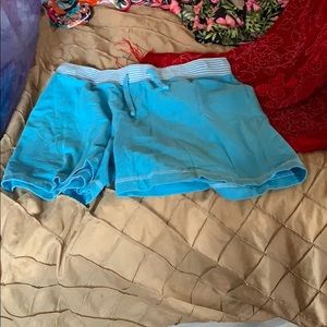 Blue shorts with stripes around the waist